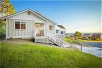 Exterior of the cottage with lawn and ocean views